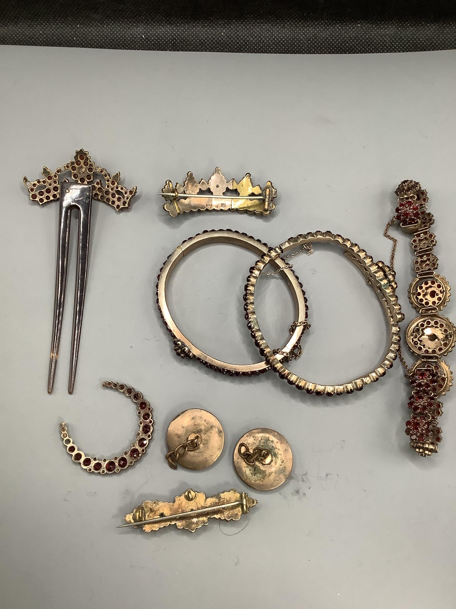 A small group of mixed Victorian gilt white metal and garnet set jewellery, including bangles, brooches, bracelet and hair ornament.